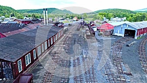 Abandoned Narrow Gauge Coal Rail Road with Rusting Hoppers and Freight Cars and Support Building