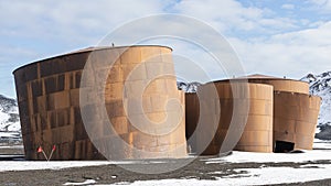 Abandoned norwegian whale hunter station rusty blubber tanks