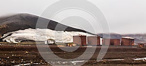Abandoned norwegian whale hunter station rusty blubber tanks panorama at Deception island, Antarctic