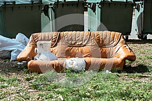 Abandoned obsolete leather sofa on street