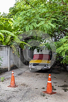 Abandoned old car in the tropical forest in Bangkok Thailand