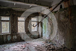 Abandoned, old. creepy, ruined room covered in moss in the building located in the Chernobyl ghost town