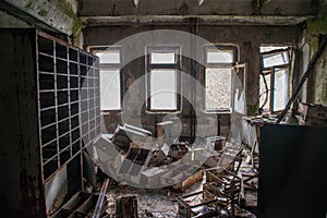 Abandoned, old. creepy, ruined room with furniture covered in moss in the building located in the Chernobyl ghost town