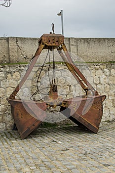 An abandoned old double bucket from a excavator at the naval station in Varna