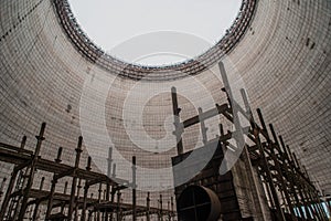 Abandoned old grading cooling thermal tower near nuclear plant located in the Chernobyl ghost town