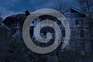 Abandoned old haunted house with dark horror atmosphere in the moonlight