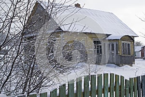 Abandoned old house in belarussian village, winter day