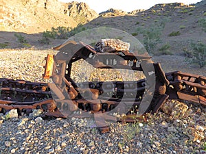 Abandoned Old Machine Treads with Rock on Top Rusting in Arizona Desert