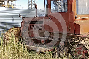 Abandoned old orange bulldozer. Earth-moving equipment. Close-up. Construction heavy machinery