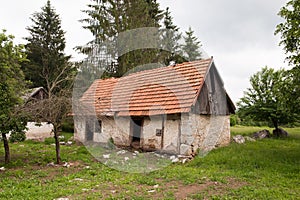 Abandoned old rural house with red rood. Village house