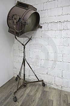 Abandoned old rustic metal spotlight with stand