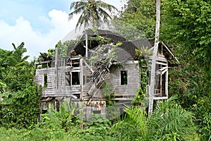 An abandoned old traditional wooden house near tropical rainforest, Phang Nga, Thailand