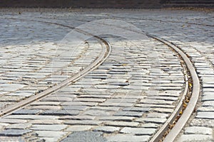 Abandoned old tram railway on cobblestones. Selective focus, shallow depth of field, blur