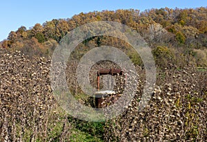 Abandoned old well on a ranch on a Sunny autumn day.