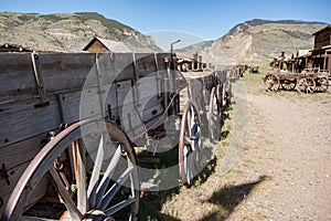 Abandoned Old West Log Buildings and Wooden Wagons