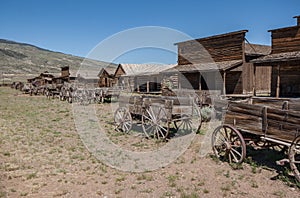 Abandoned Old West Log Buildings and Wooden Wagons