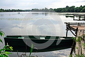 Abandoned Old Wooden Fishing Boat Near Pier In Summer Lake Or River. Beautiful Summer Sunny Day Or Evening. Forsaken Boat