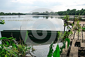 Abandoned Old Wooden Fishing Boat Near Pier In Summer Lake Or River. Beautiful Summer Sunny Day Or Evening. Forsaken Boat