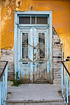 Abandoned old building with decayed chained front door photo