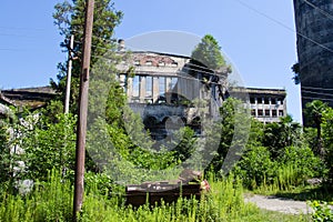 Abandoned overgrown ruins of destroyed by war Tkvarcheli Tquarhcal power plant, Abkhazia, Georgia