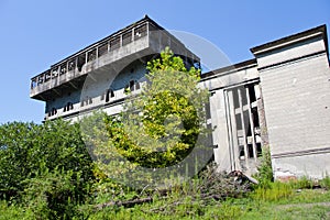 Abandoned overgrown ruins of destroyed by war Tkvarcheli Tquarhcal power plant, Abkhazia, Georgia