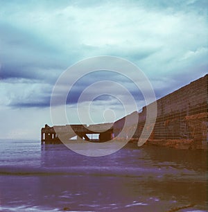 An abandoned pier on the Tuscan sea in Autumn at sunset with long exposure effect with slide film photography - 5