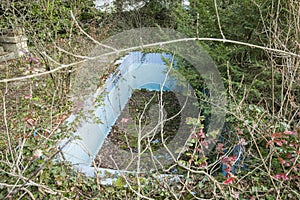 Abandoned pool in ruined villa