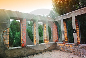 Abandoned porch illuminated by sunset beams