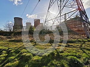 An abandoned power station with pylon and sunset