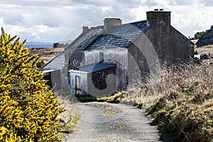 Abandoned property or house on Arranmore island, Republic of Ireland County Donegal. Derelict or destitute home shows Irish rural photo