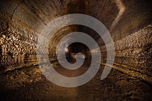 Abandoned prospecting adit. Tunnel at limestone at abandoned mine