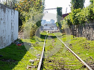Abandoned railroad. Old rails. Path among buildings