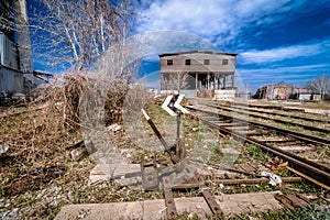 Abandoned railway station . Rusty weathered peeled paint of an old wagon. Blue railway carriage.