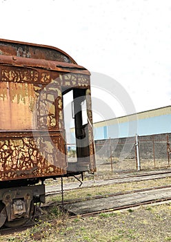 Abandoned railway train car on track siding.