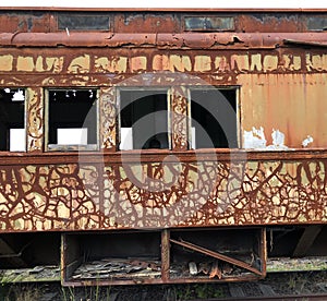 Abandoned railway train car on track siding.