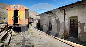 The abandoned railway wagons with damaged warehouse buildings