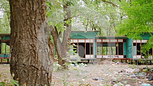 Abandoned recreation center and houses in the forest. Poverty and homelessness