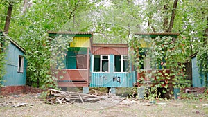 Abandoned recreation center and houses in the forest. Poverty and homelessness