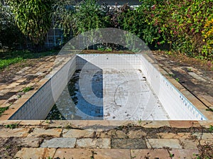 An abandoned recreational swimming pool without water.