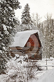 Abandoned red barn in winter scene covered in snow