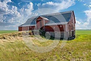 An abandoned red basement or bank barn on the Saskatchewan prairies