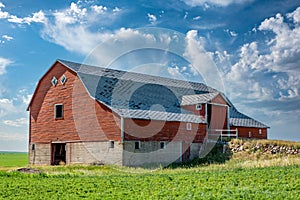 An abandoned red basement or bank barn on the Saskatchewan prairies