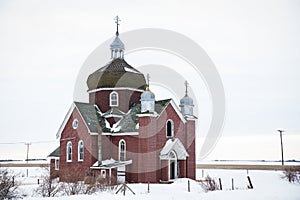 An abandoned red brick Catholic Church