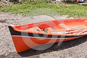 Abandoned red wooden boat at the coast of the island Martinique