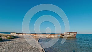 An abandoned reinforced concrete barge lies on a sandbank on the edge of the Kinburn Spit, Ukraine