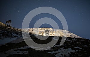 Abandoned remains of a coal cableway in a polar night light