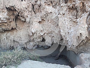 An abandoned reservoir of irrigation water sculptured under a talus