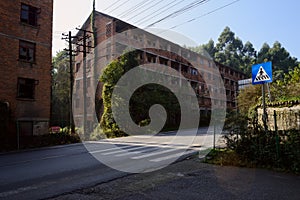 Abandoned roadside red-brick multi-storied apartment of 1970s