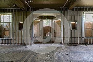 Abandoned Room with Boarded Windows and Peeling Ceiling Paint