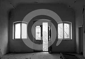 Abandoned room with door and two windows